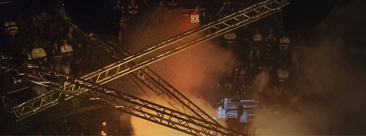 Lighting trusses in warm haze above the audience